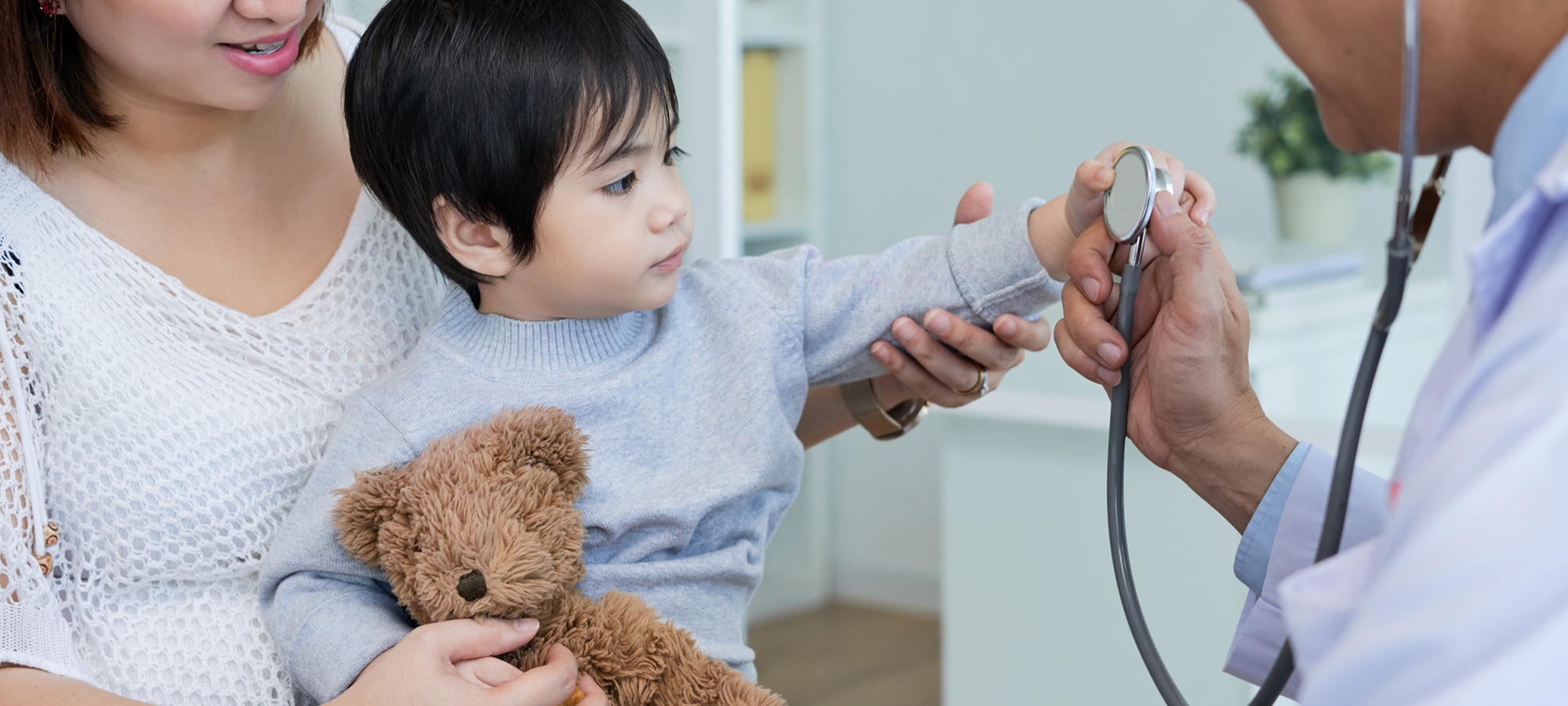 infant inspecting doctors stethoscope